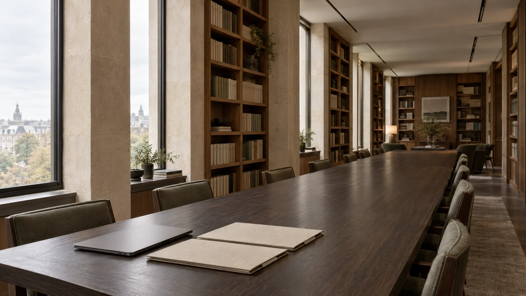 A quiet, wood-lined reading room with a long review table, orderly folders and soft daylight.